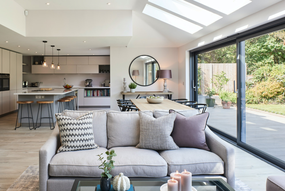 Inspiration for a large contemporary open concept living room in Hertfordshire with a two-sided fireplace.