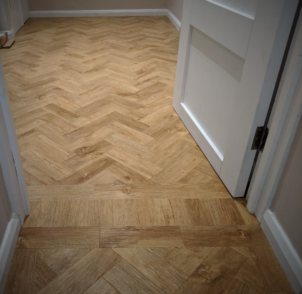 Inspiration for a mid-sized transitional hallway in Hertfordshire with grey walls, vinyl floors and brown floor.