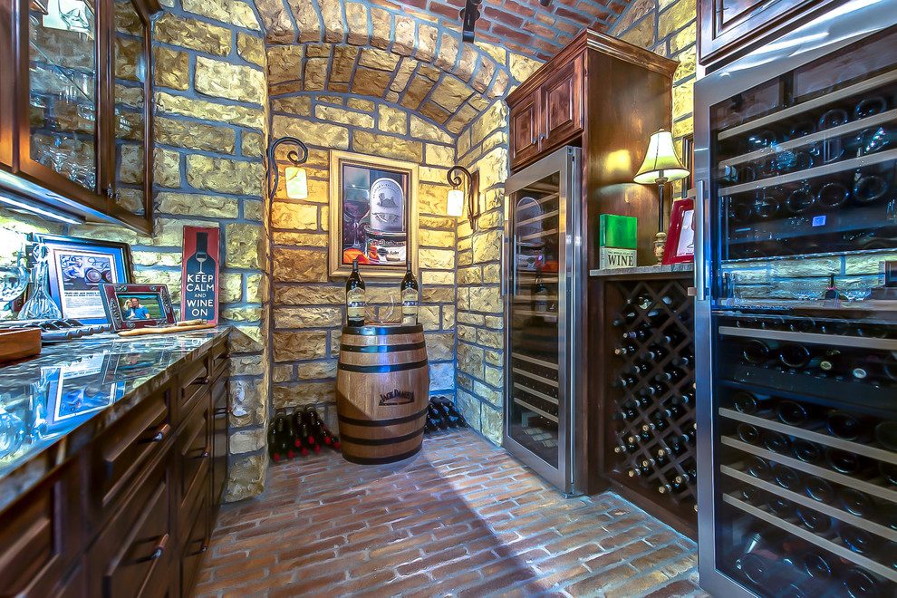This is an example of a mid-sized mediterranean wine cellar in Austin with terra-cotta floors.