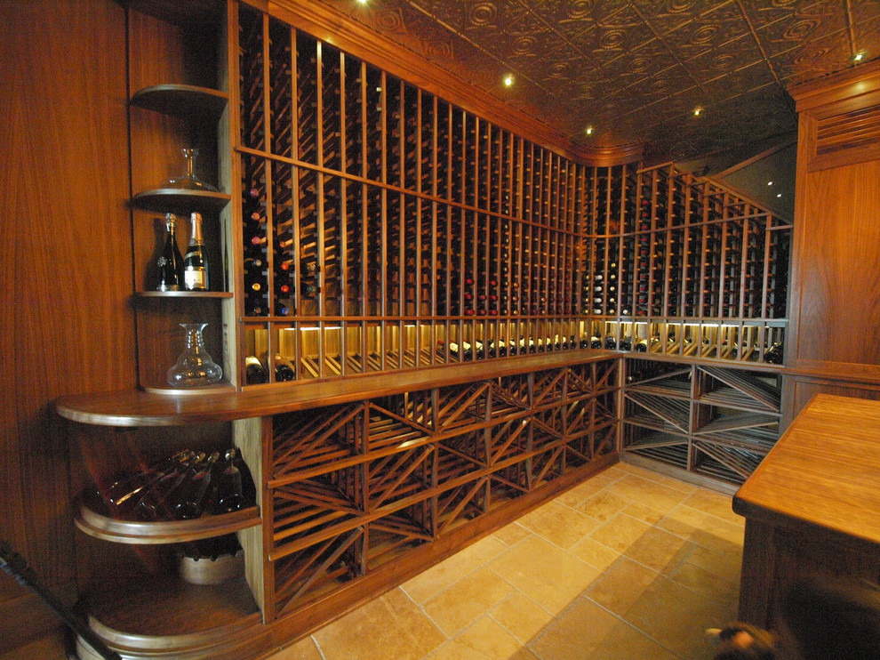 Mid-sized traditional wine cellar in Calgary with travertine floors, storage racks and beige floor.