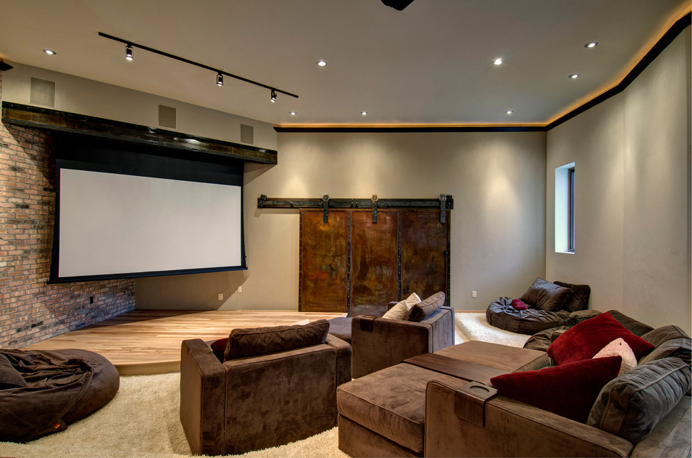 This is an example of a contemporary home theatre in Denver with grey walls and a projector screen.