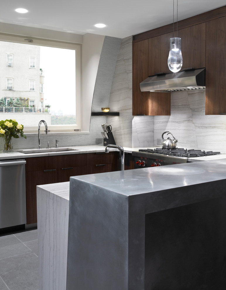 Photo of a contemporary kitchen in New York with stone slab splashback, an undermount sink and white splashback.