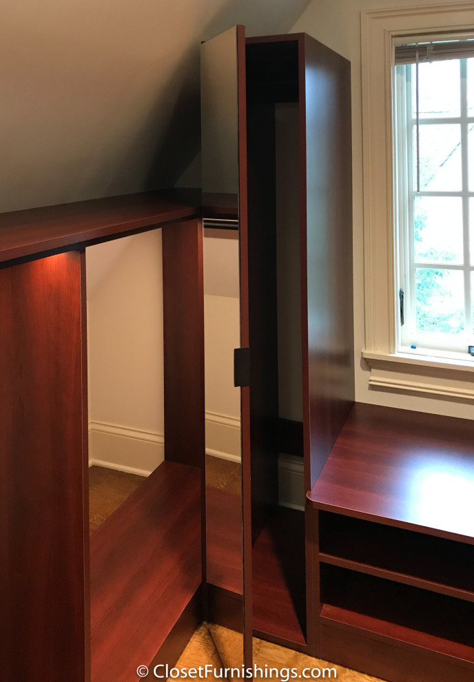 Photo of a mid-sized modern gender-neutral walk-in wardrobe in Chicago with flat-panel cabinets, red cabinets and dark hardwood floors.