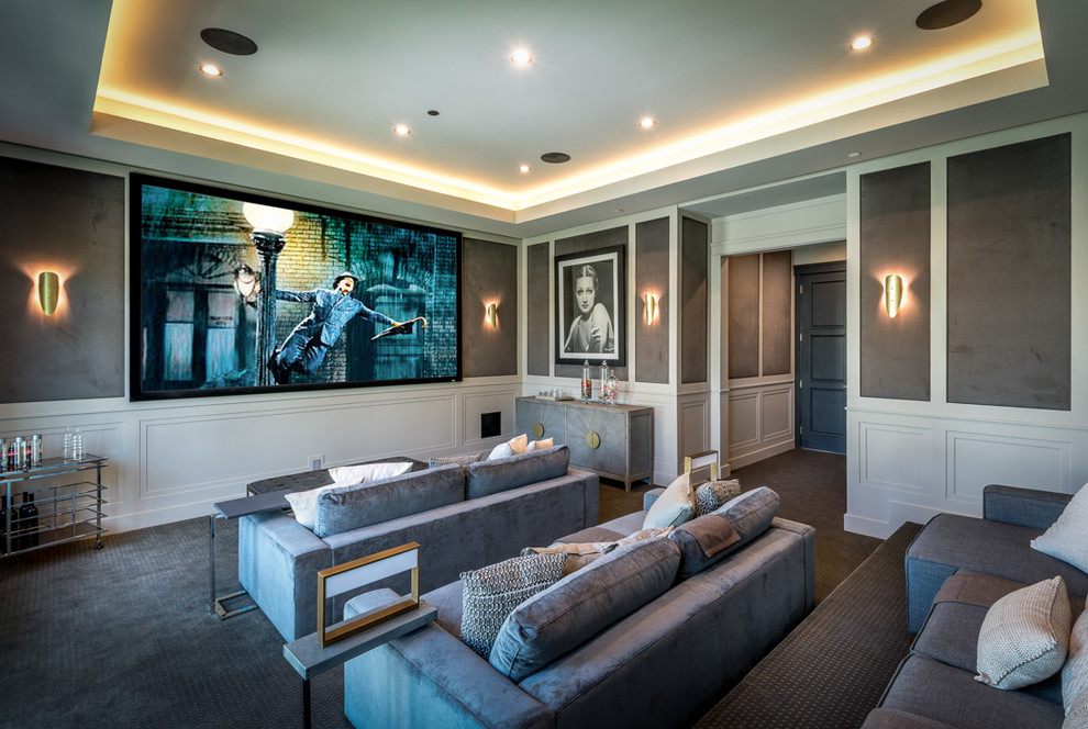 This is an example of a transitional enclosed home theatre in Los Angeles with grey walls, carpet, a wall-mounted tv and grey floor.