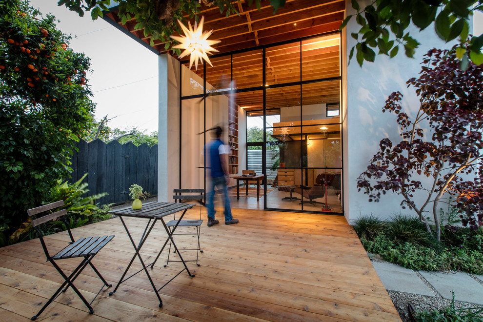 Deck - modern freestanding desk concrete floor deck idea in Los Angeles with white walls