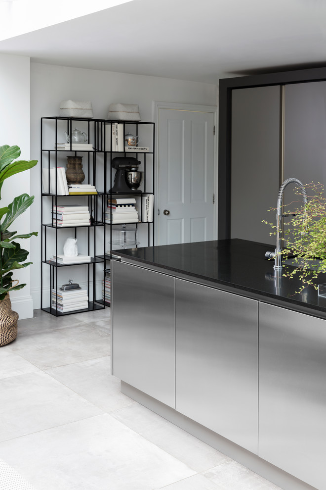 Large contemporary single-wall eat-in kitchen in London with recessed-panel cabinets, stainless steel cabinets and with island.