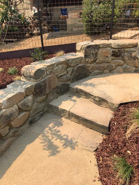 DG pathway with natural stacked stone wall