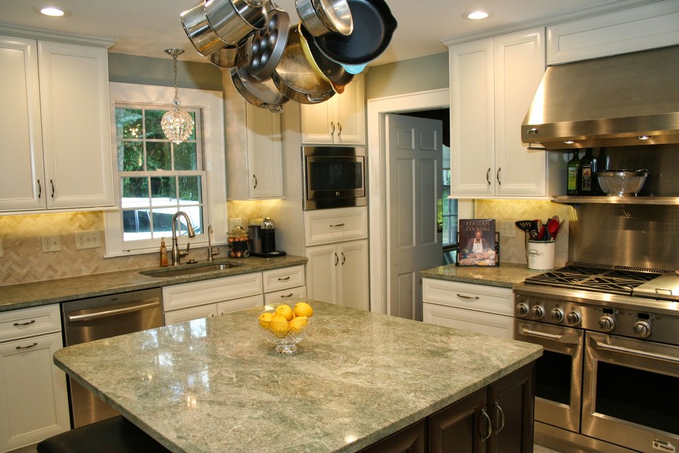 Enclosed kitchen - mid-sized transitional u-shaped ceramic tile enclosed kitchen idea in Boston with a single-bowl sink, recessed-panel cabinets, white cabinets, granite countertops, green backsplash, stone tile backsplash, stainless steel appliances and an island