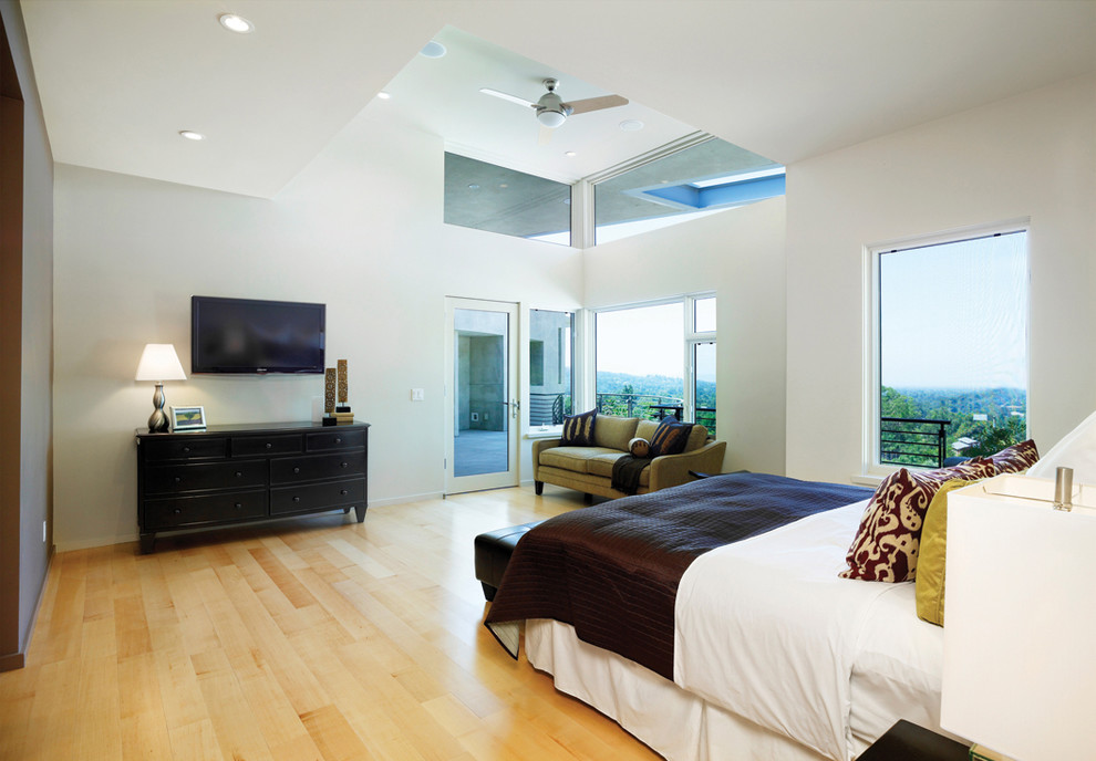 Modern bedroom in Los Angeles with white walls and light hardwood floors.