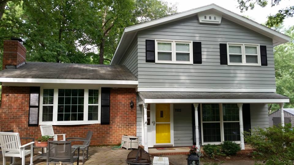 This is an example of a mid-sized traditional two-storey grey exterior in Raleigh with wood siding and a gable roof.
