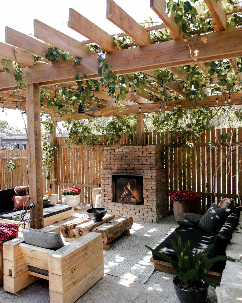 Inspiration for a mid-sized backyard patio remodel in Minneapolis with a fireplace and a pergola