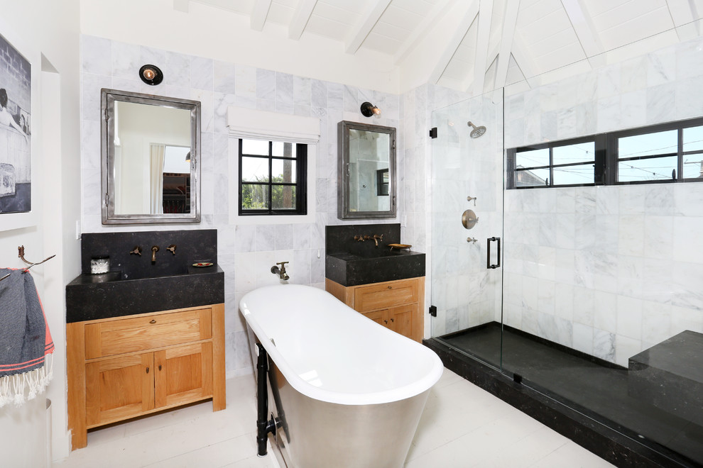 Master gray tile freestanding bathtub photo in Orange County with flat-panel cabinets and light wood cabinets