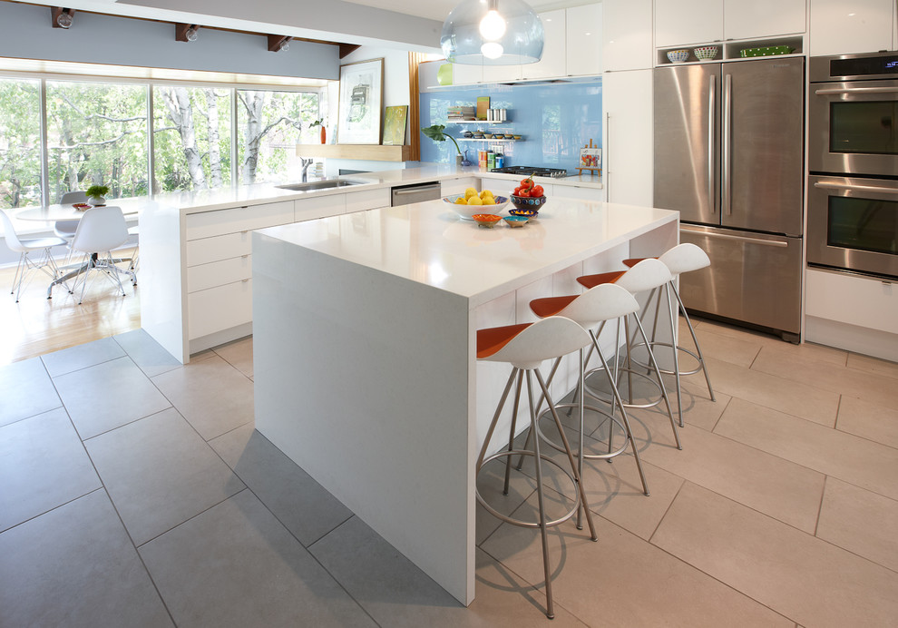 Inspiration for a modern eat-in kitchen in Toronto with flat-panel cabinets, white cabinets, quartz benchtops, blue splashback, glass sheet splashback and stainless steel appliances.