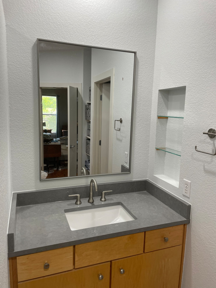 Design ideas for a mid-sized contemporary master bathroom in Austin with flat-panel cabinets, light wood cabinets, grey walls, an undermount sink, engineered quartz benchtops, grey benchtops, a single vanity and a built-in vanity.