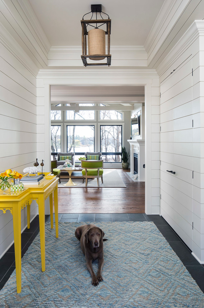 Photo of a beach style entryway in Minneapolis with white walls.