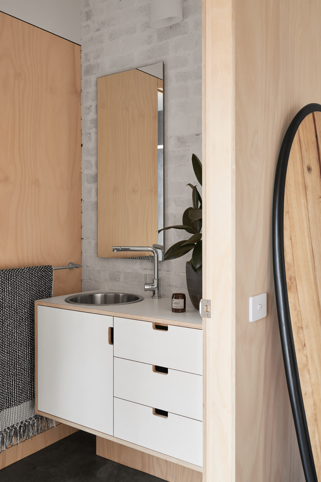 Contemporary powder room in Melbourne with flat-panel cabinets, white cabinets, grey walls, a drop-in sink, a one-piece toilet, concrete floors, wood benchtops, grey floor and white benchtops.