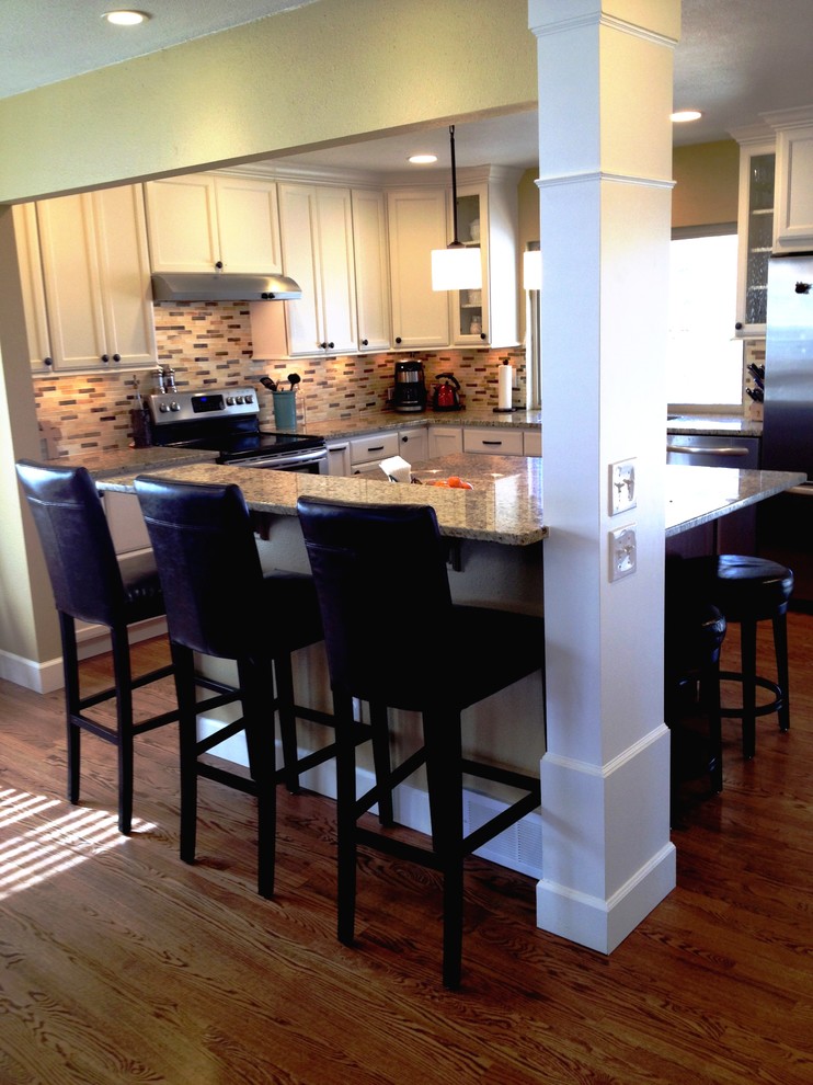 Inspiration for a transitional eat-in kitchen remodel in Denver with an undermount sink, shaker cabinets, white cabinets, granite countertops, multicolored backsplash and stainless steel appliances