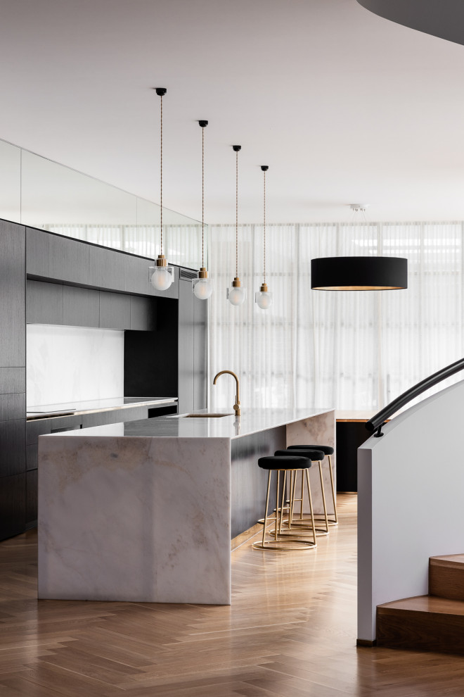 Design ideas for a mid-sized contemporary galley eat-in kitchen in Melbourne with marble benchtops, marble splashback, medium hardwood floors and with island.