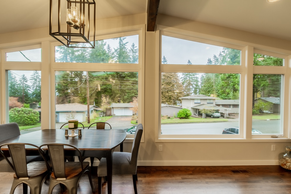 Example of a minimalist medium tone wood floor and brown floor kitchen/dining room combo design in Seattle