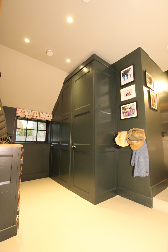Photo of a mid-sized country powder room in Oxfordshire with recessed-panel cabinets.