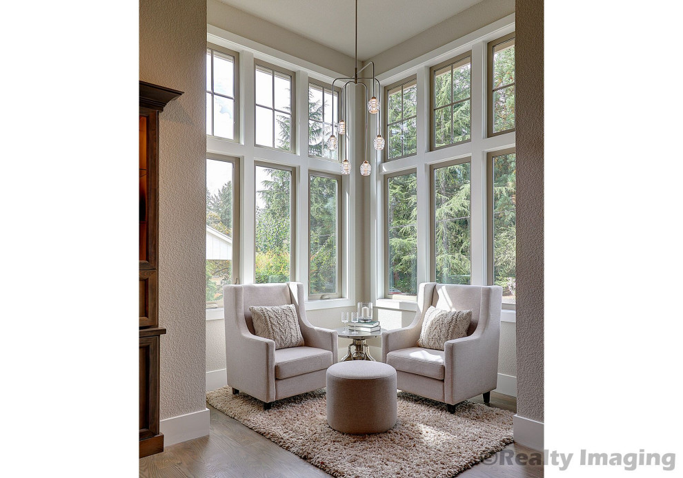 Photo of a small sunroom in Portland with light hardwood floors, a standard ceiling and grey floor.