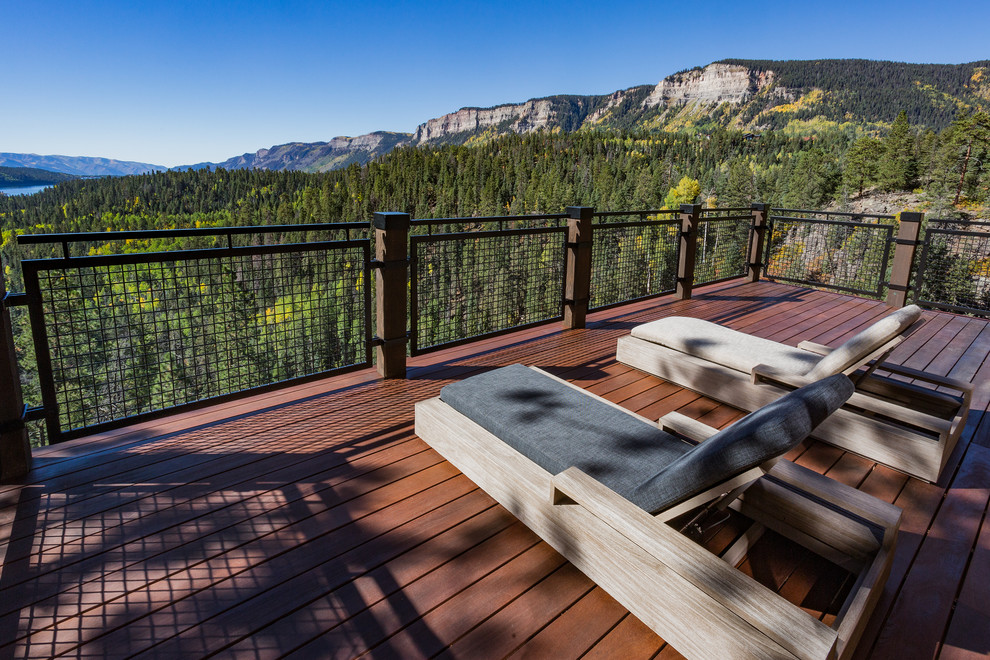 Large mountain style backyard deck photo with no cover