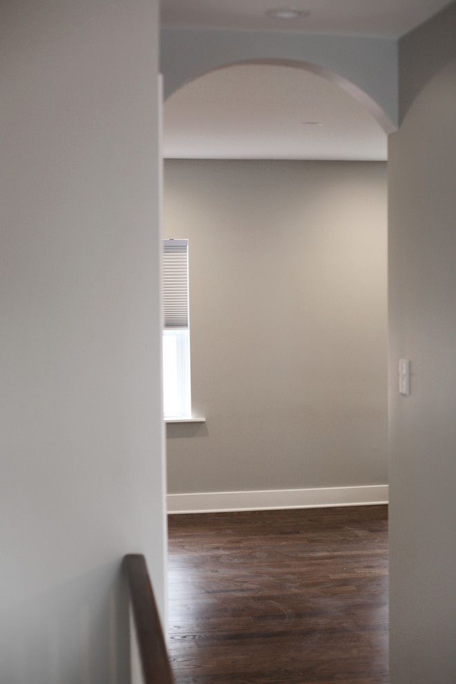 Inspiration for a mid-sized transitional hallway in Philadelphia with grey walls, dark hardwood floors and brown floor.