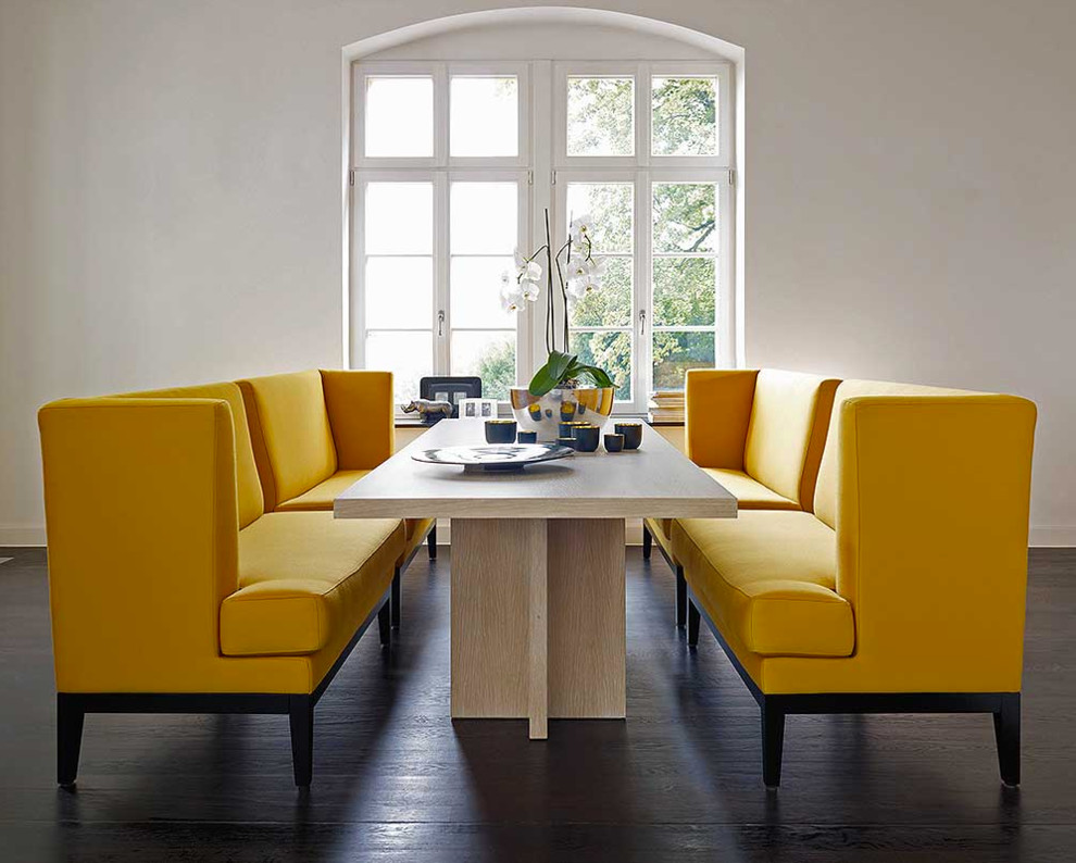 Inspiration for a mid-sized contemporary dining room in Bremen with white walls, dark hardwood floors and no fireplace.
