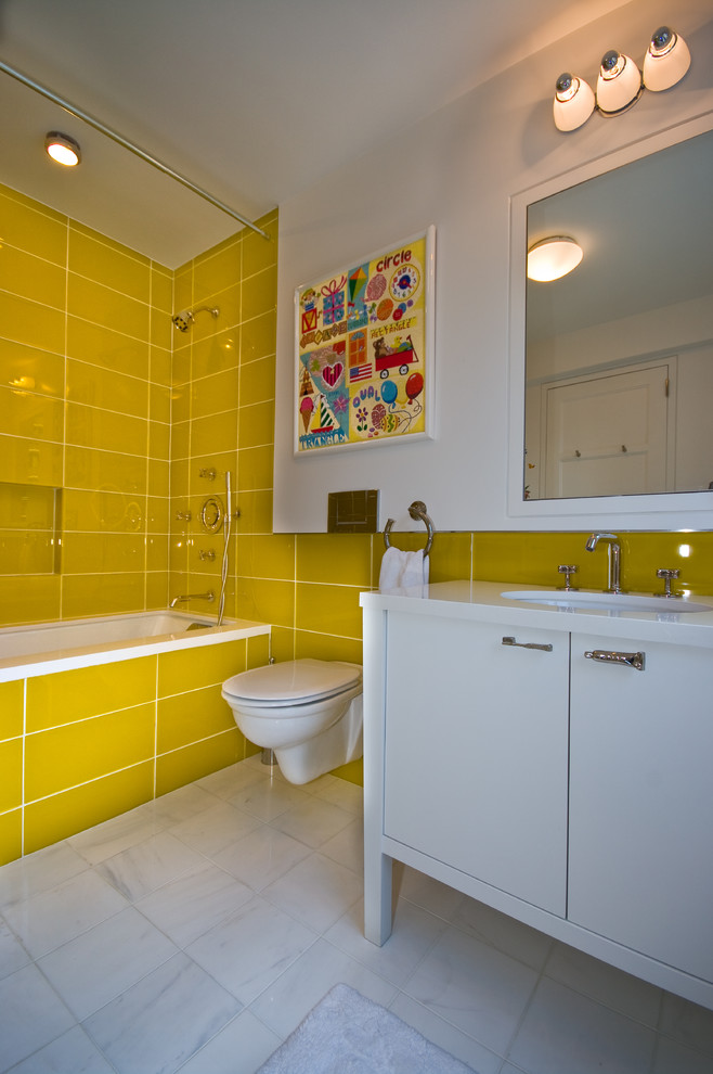 Inspiration for a modern bathroom in New York with engineered quartz benchtops, yellow tile, glass tile and marble floors.