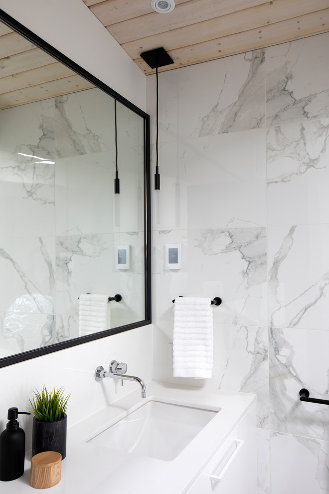 Inspiration for a mid-sized midcentury master bathroom in Vancouver with flat-panel cabinets, white cabinets, a freestanding tub, a curbless shower, a one-piece toilet, white tile, white walls, an undermount sink, engineered quartz benchtops, grey floor, an open shower, white benchtops, marble and concrete floors.