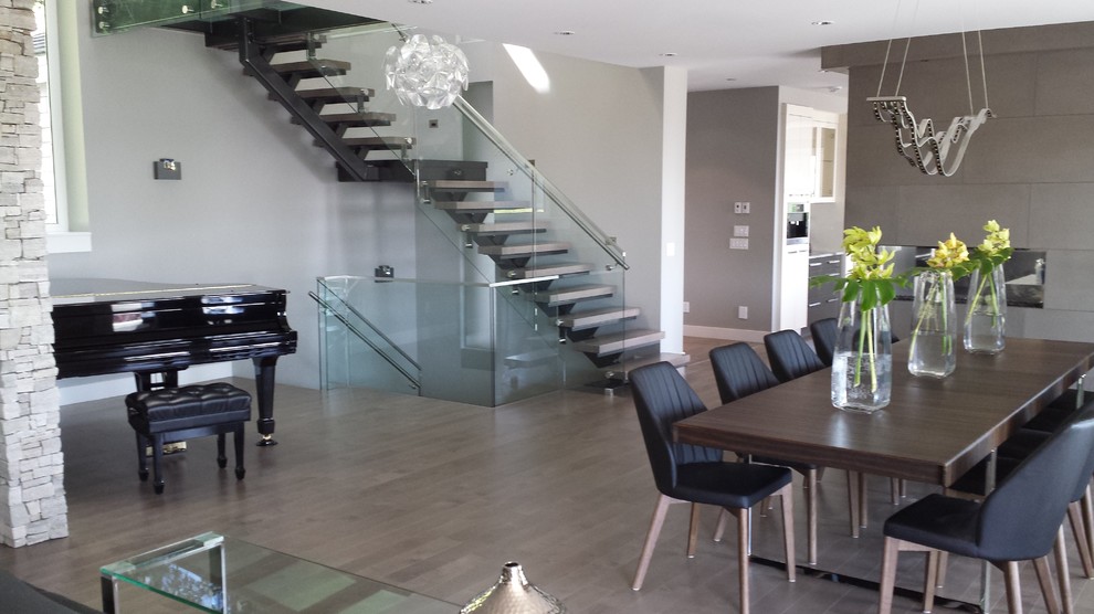 Mid-sized contemporary glass floating staircase in Vancouver with open risers.