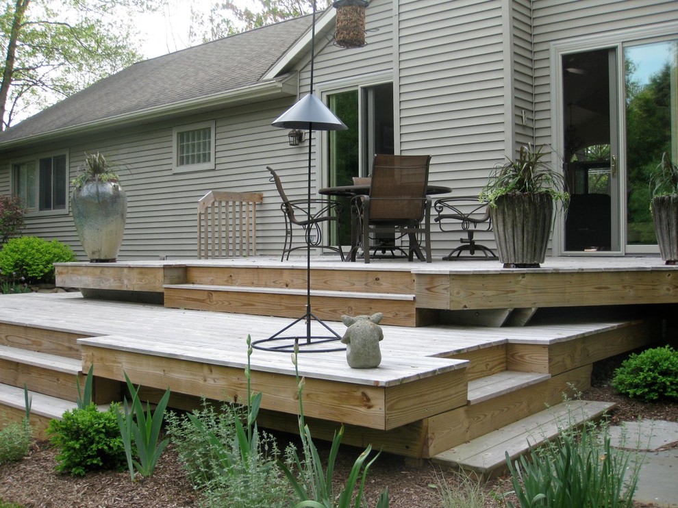 Mid-sized trendy backyard deck photo in Grand Rapids