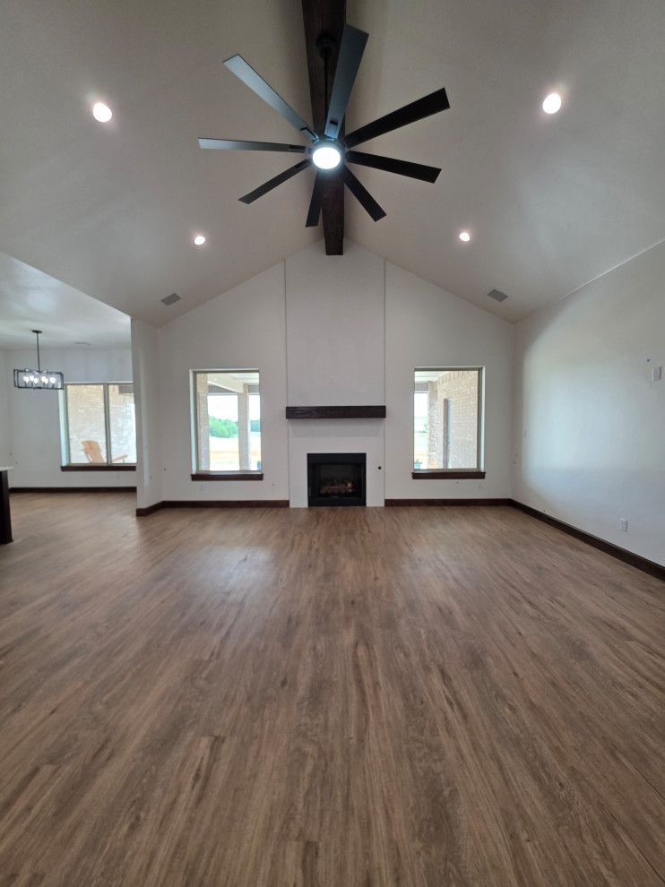 The natural gas fireplace is accented by large picture windows