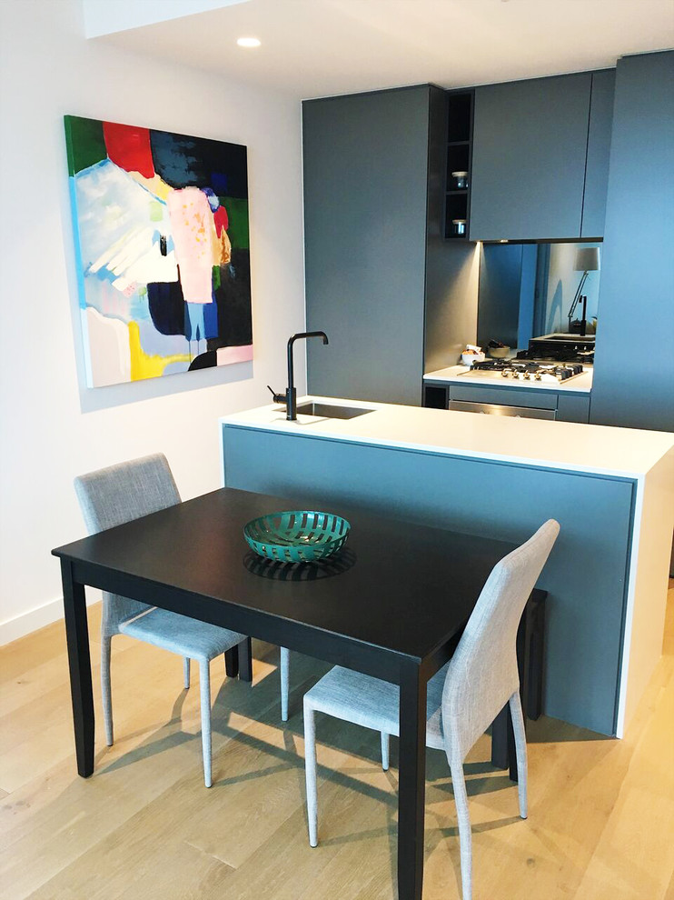 Photo of a small modern galley eat-in kitchen in Melbourne with with island.