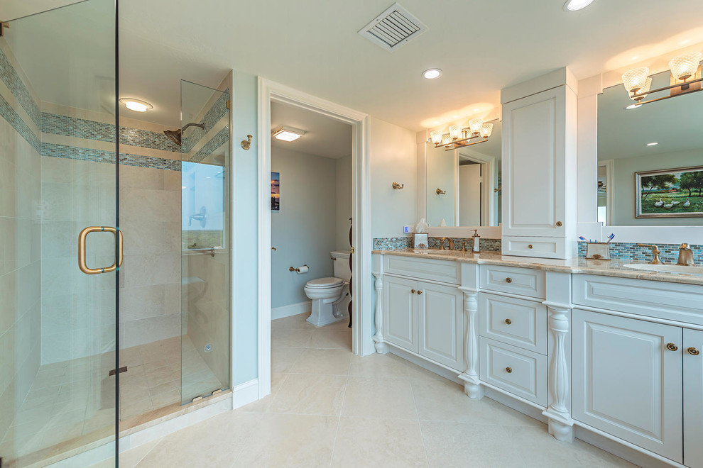Transitional master glass tile porcelain tile bathroom photo with an undermount sink and marble countertops