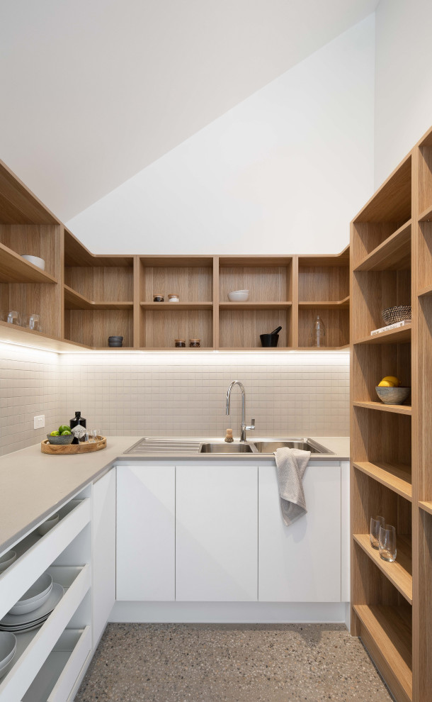 Стильный дизайн: параллельная кухня среднего размера, в белых тонах с отделкой деревом в современном стиле с кладовкой, накладной мойкой, белым фартуком, бетонным полом и серым полом - последний тренд