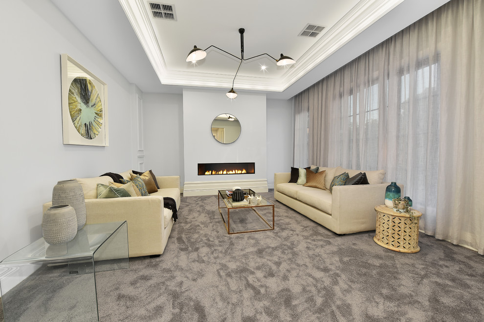 Photo of a large traditional formal enclosed living room in Melbourne with grey walls, carpet, a ribbon fireplace, a plaster fireplace surround and grey floor.