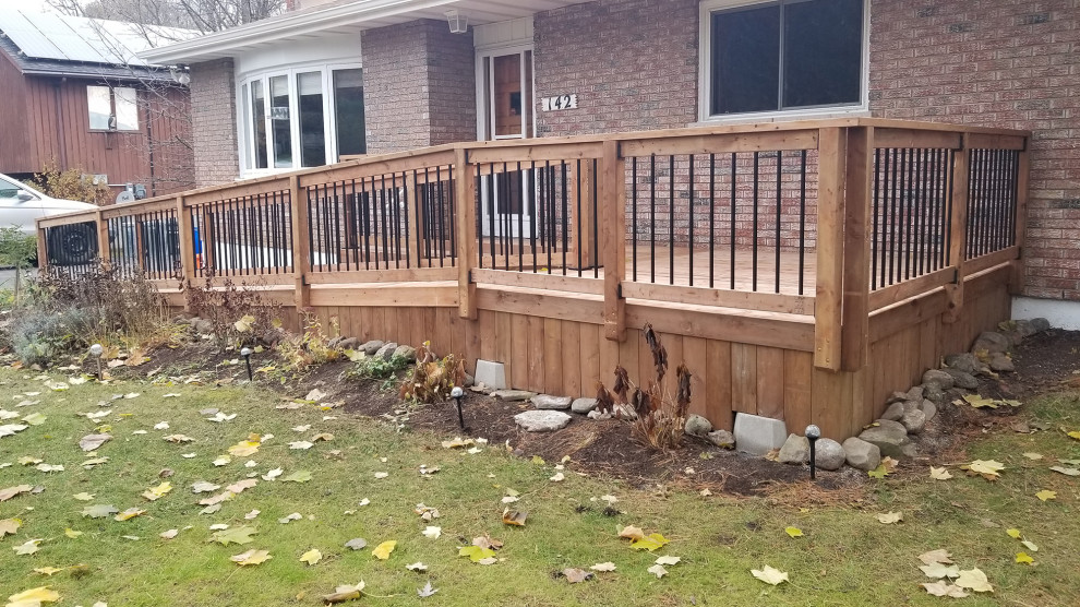 Inspiration for a mid-sized modern ground level deck in Ottawa with with skirting, no cover and mixed railing.