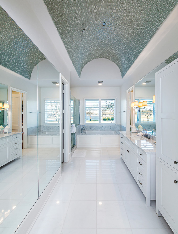 Photo of a large contemporary bathroom in Dallas with an undermount sink, shaker cabinets, white cabinets, limestone benchtops, an undermount tub, a corner shower, a two-piece toilet, white tile, porcelain tile, white walls and ceramic floors.