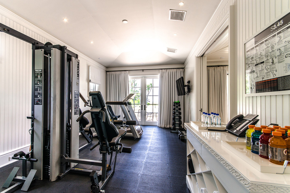 Inspiration for an expansive beach style multipurpose gym in Miami with white walls, black floor and vaulted.