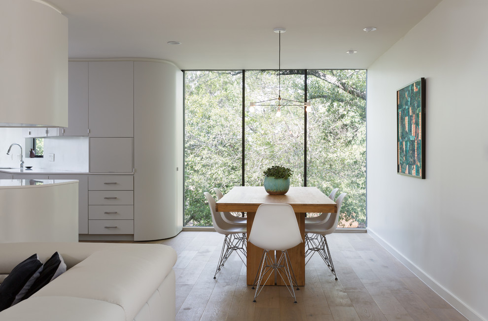 Great room - large scandinavian light wood floor and brown floor great room idea in Austin with white walls and no fireplace