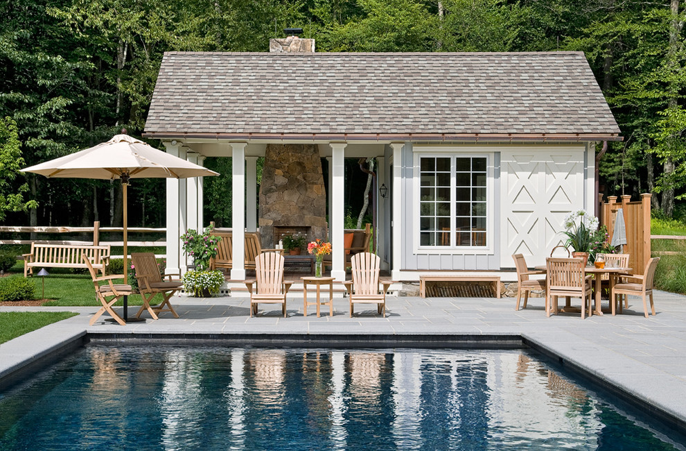 Design ideas for a country rectangular pool in New York with a pool house and concrete pavers.
