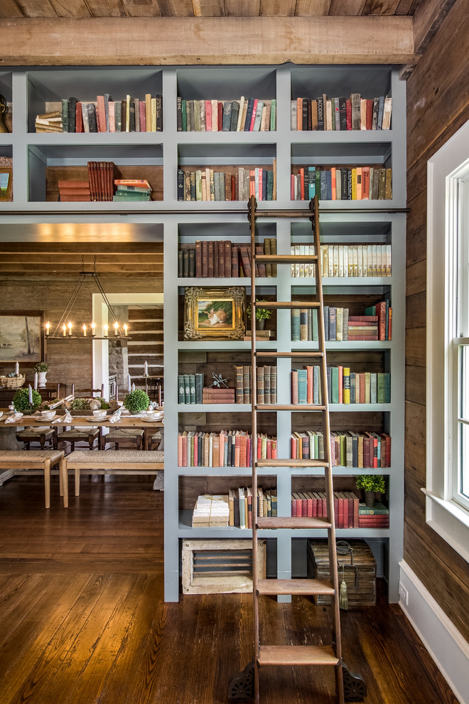Inspiration for a country family room in Nashville with a library, brown walls and medium hardwood floors.