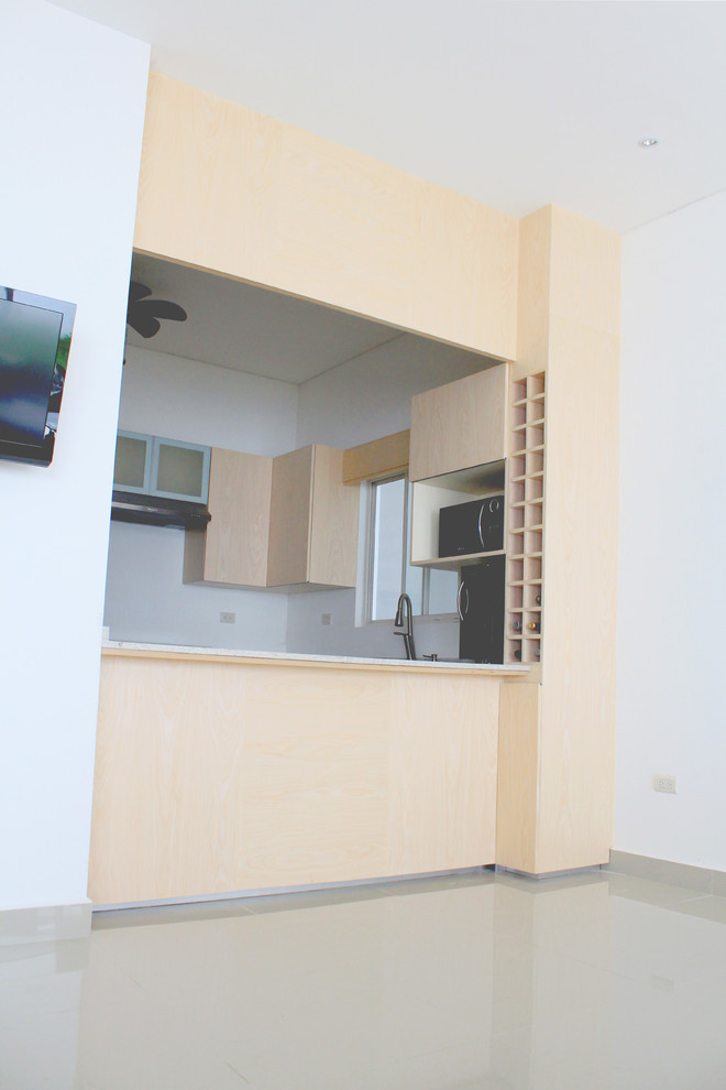 Eat-in kitchen - mid-sized modern u-shaped porcelain tile eat-in kitchen idea with a double-bowl sink, flat-panel cabinets, light wood cabinets, granite countertops and stainless steel appliances