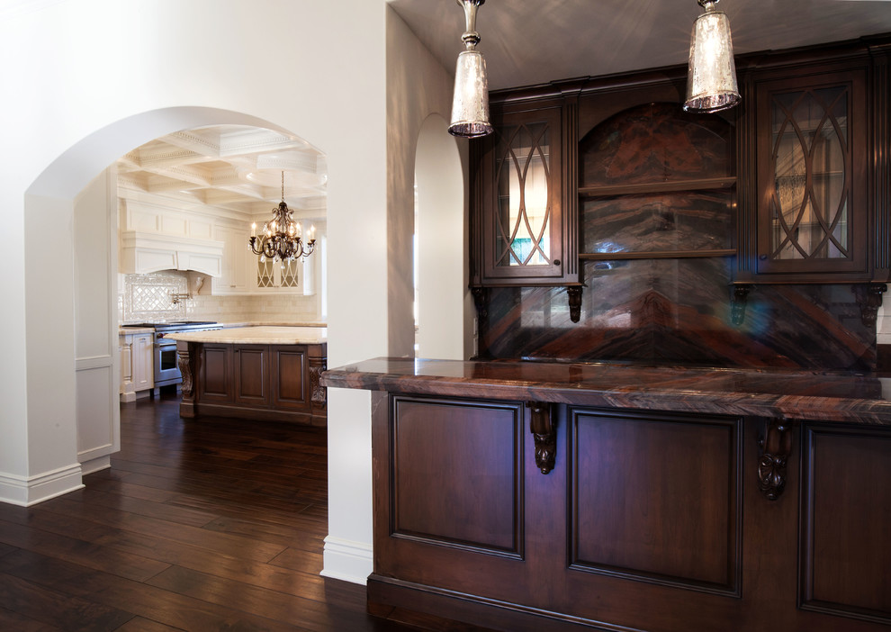 This is an example of a mid-sized traditional l-shaped wet bar in Los Angeles with an undermount sink, beaded inset cabinets, dark wood cabinets, marble benchtops, brown splashback, stone slab splashback and dark hardwood floors.