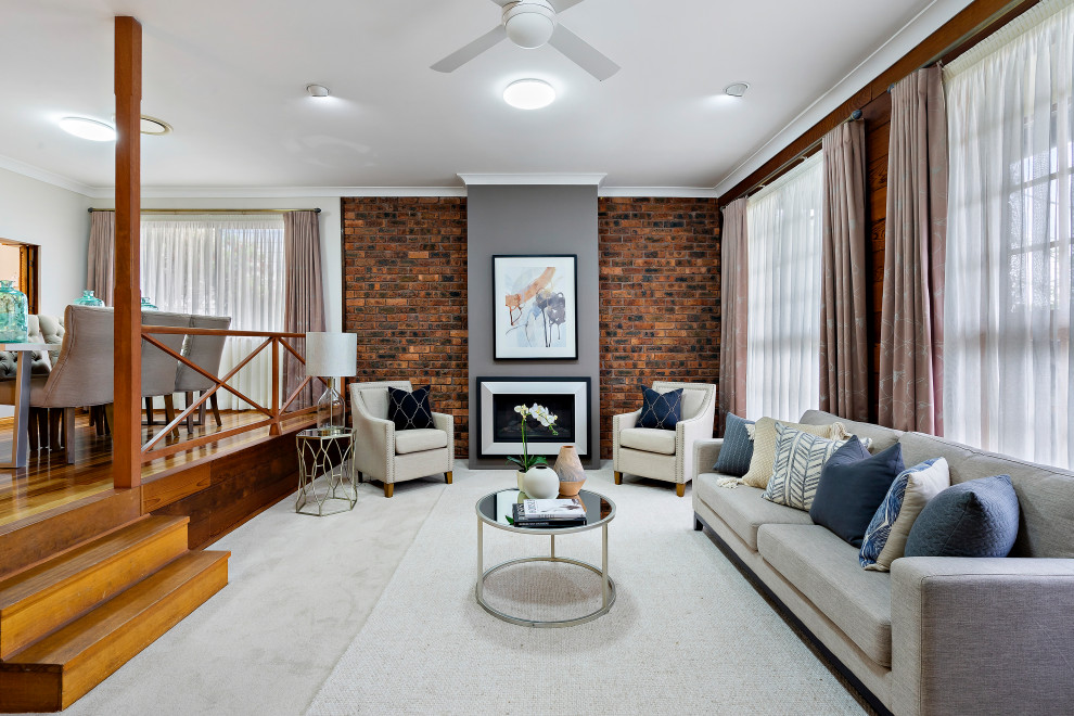 Design ideas for a large transitional open concept family room in Sydney with white walls, carpet, a brick fireplace surround and white floor.