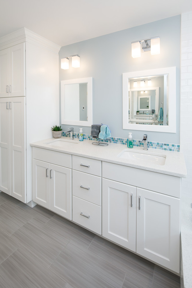 Design ideas for a large beach style wet room bathroom in Philadelphia with flat-panel cabinets, white cabinets, a drop-in tub, a bidet, blue tile, mosaic tile, blue walls, porcelain floors, an undermount sink, engineered quartz benchtops, grey floor, an open shower and white benchtops.