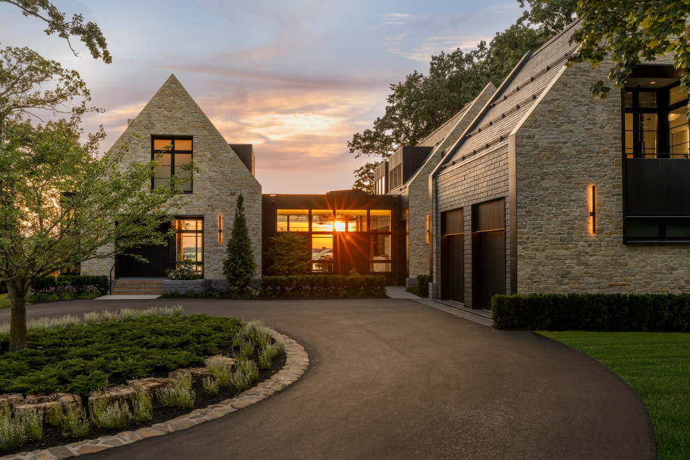 Inspiration for a contemporary two-storey beige house exterior in Minneapolis with stone veneer and a gable roof.