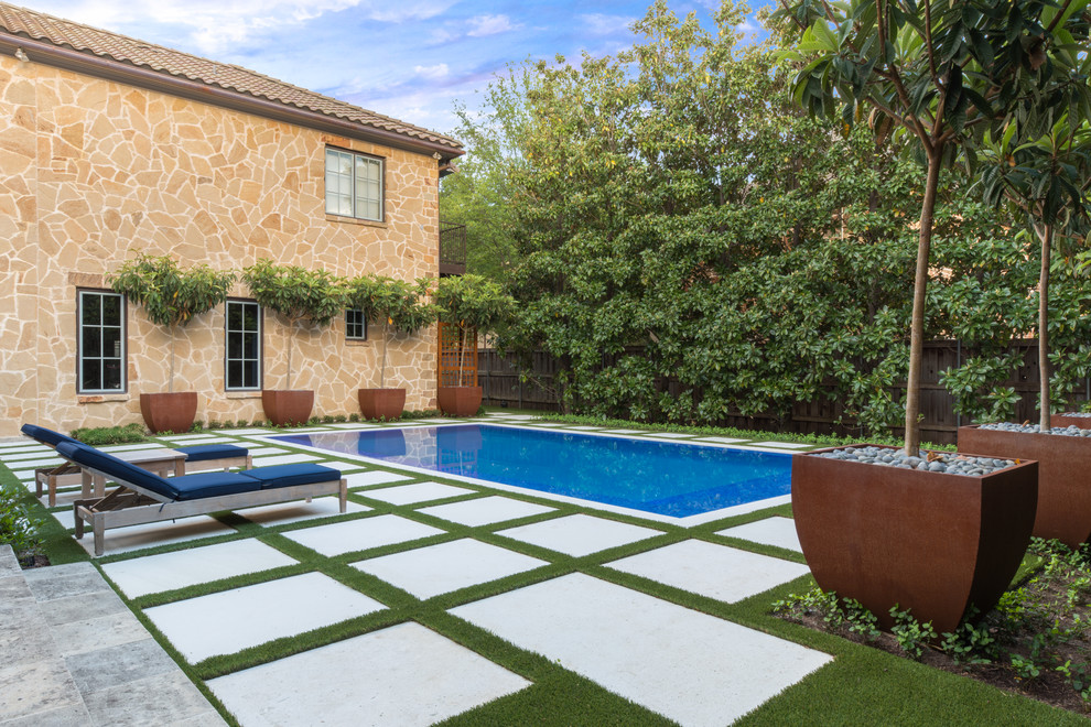 Photo of a mediterranean backyard rectangular pool in Dallas with concrete pavers.