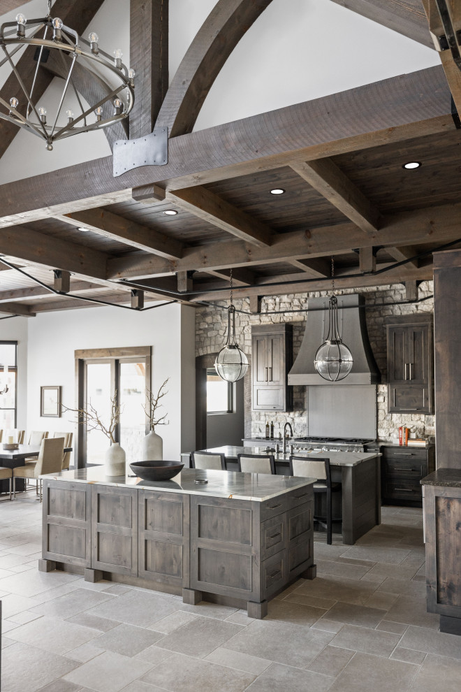 Example of a large mountain style l-shaped porcelain tile, beige floor and coffered ceiling kitchen design in Indianapolis with an undermount sink, recessed-panel cabinets, medium tone wood cabinets, quartzite countertops, gray backsplash, stone tile backsplash, paneled appliances, two islands and white countertops